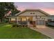 Charming home with cozy porch, manicured lawn, and warm evening glow at 8677 Sw 95Th Ln # A, Ocala, FL 34481