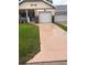 Charming home featuring a well-maintained lawn, concrete driveway, and an attached garage at 8677 Sw 95Th Ln # A, Ocala, FL 34481