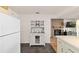 Kitchen and dining area featuring a hutch with display cabinets and a modern refrigerator at 8677 Sw 95Th Ln # A, Ocala, FL 34481