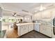 Bright, open kitchen with white cabinetry and eat-in counter that flows to the living room at 8677 Sw 95Th Ln # A, Ocala, FL 34481