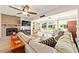 Cozy living room featuring a fireplace, lots of natural light, and comfortable seating at 8677 Sw 95Th Ln # A, Ocala, FL 34481