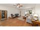 Comfortable living room with wood floors, neutral paint, ceiling fan, and stylish furniture at 8677 Sw 95Th Ln # A, Ocala, FL 34481