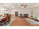 Open-concept living and dining area with wood floors and neutral walls, perfect for entertaining at 8677 Sw 95Th Ln # A, Ocala, FL 34481