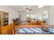 Open living space with wood floors, neutral paint, ceiling fan, and stylish furniture at 8677 Sw 95Th Ln # A, Ocala, FL 34481