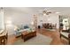 Open living space with wood floors, adjacent dining area, and a ceiling fan at 8677 Sw 95Th Ln # A, Ocala, FL 34481