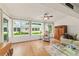 Bright sunroom featuring large windows overlooking the backyard and comfortable seating at 8677 Sw 95Th Ln # A, Ocala, FL 34481
