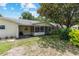 Spacious backyard featuring a screened-in patio, mature landscaping, and lush lawn perfect for outdoor activities at 9065 Sw 82Nd Ter # G, Ocala, FL 34481