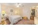 Bright bedroom featuring a floral comforter, ceiling fan and large closet, creating a calming retreat at 9065 Sw 82Nd Ter # G, Ocala, FL 34481
