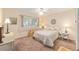Cozy bedroom featuring a ceiling fan, window, and floral bedding, creating a warm and inviting atmosphere at 9065 Sw 82Nd Ter # G, Ocala, FL 34481