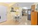 Bright dining area featuring laminate floors and an adjacent kitchen with modern appliances for convenience at 9065 Sw 82Nd Ter # G, Ocala, FL 34481