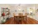 Bright dining room featuring wood floors, table, and a decorative shelving unit for displaying decor at 9065 Sw 82Nd Ter # G, Ocala, FL 34481