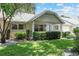 Charming home with manicured front yard, decorative stone accents, and a welcoming covered porch entry at 9065 Sw 82Nd Ter # G, Ocala, FL 34481