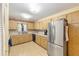 Well-equipped kitchen with wood cabinets, laminate floors, modern appliances, and ample counter space at 9065 Sw 82Nd Ter # G, Ocala, FL 34481