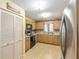 Efficient kitchen with wood cabinets, laminate floors, and modern appliances for easy meal preparation at 9065 Sw 82Nd Ter # G, Ocala, FL 34481