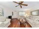 Bright and airy living room with hardwood floors, ceiling fan, and comfortable seating at 9065 Sw 82Nd Ter # G, Ocala, FL 34481