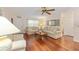 Inviting living room boasts hardwood floors, a ceiling fan, and neutral-toned sofas for relaxed living at 9065 Sw 82Nd Ter # G, Ocala, FL 34481