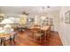 Open-concept living space featuring hardwood floors, dining area, and comfortable seating, ideal for entertaining at 9065 Sw 82Nd Ter # G, Ocala, FL 34481