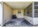 Enclosed patio with concrete floor, air conditioning unit, and screened windows, offering an inviting outdoor space at 9065 Sw 82Nd Ter # G, Ocala, FL 34481