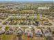 Aerial view of houses, meticulously maintained lawns, and mature trees in a vibrant community at 9415 Se 125Th St, Summerfield, FL 34491