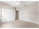 Bedroom with carpet, closet, ceiling fan and a connecting bathroom at 9415 Se 125Th St, Summerfield, FL 34491