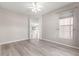 Bedroom with hardwood flooring, ceiling fan, and large windows, offering ample natural light at 9415 Se 125Th St, Summerfield, FL 34491