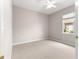 Bedroom with carpet, ceiling fan, window and neutral wall paint at 9415 Se 125Th St, Summerfield, FL 34491