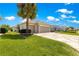 Home featuring a three-car garage, custom driveway, and manicured lawn with mature landscaping at 9415 Se 125Th St, Summerfield, FL 34491
