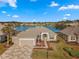 Charming single-story home boasts a beautiful lake view, mature landscaping, and a spacious three-car garage at 9415 Se 125Th St, Summerfield, FL 34491