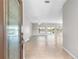 Inviting foyer with tile flooring leading to a spacious living area with expansive windows and a lake view at 9415 Se 125Th St, Summerfield, FL 34491