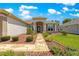 Charming home with a stone walkway, lush landscaping, and an inviting front entrance at 9415 Se 125Th St, Summerfield, FL 34491