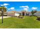 Attractive home boasts a well-manicured lawn with mature landscaping and a spacious three-car garage at 9415 Se 125Th St, Summerfield, FL 34491