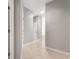 Hallway features neutral paint, tile floors, and a skylight for natural lighting at 9415 Se 125Th St, Summerfield, FL 34491