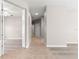 Hallway with tile flooring leading to rooms with hardwood and carpet at 9415 Se 125Th St, Summerfield, FL 34491
