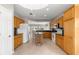 Spacious kitchen featuring tile floors, wood cabinetry, granite countertops and modern appliances at 9415 Se 125Th St, Summerfield, FL 34491