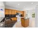 Kitchen with granite countertops, wooden cabinetry, and modern stainless appliances at 9415 Se 125Th St, Summerfield, FL 34491