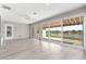 Bright sunroom features sliding glass doors with views of a tranquil lake at 9415 Se 125Th St, Summerfield, FL 34491