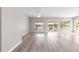 Bright living room with laminate flooring and expansive windows overlooking the lake at 9415 Se 125Th St, Summerfield, FL 34491