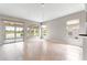 Open living space with tiled floors and sliders to the lanai with lake view at 9415 Se 125Th St, Summerfield, FL 34491