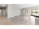 Open-concept living area featuring wood-look floors and sliders to the lanai at 9415 Se 125Th St, Summerfield, FL 34491