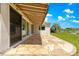 Paver patio, sheltered by an awning, provides a beautiful space with serene views of the lake at 9415 Se 125Th St, Summerfield, FL 34491