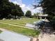 Outdoor shuffleboard courts in a park setting with lush green grass and shade trees, offering a recreational amenity at 9415 Se 125Th St, Summerfield, FL 34491