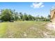 Expansive grassy backyard with mature trees and partial fencing offers plenty of space at 9562 Sw 45Th Ave, Ocala, FL 34476
