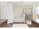 Well-lit bathroom featuring separate shower and tub, and wood look flooring at 9562 Sw 45Th Ave, Ocala, FL 34476