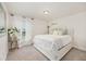 Bright bedroom with a cushioned headboard, bedside table with flowers, and a window at 9562 Sw 45Th Ave, Ocala, FL 34476