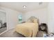 Neutral bedroom with a queen bed, window, and two bedside tables at 9562 Sw 45Th Ave, Ocala, FL 34476