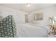 Bedroom featuring neutral walls, carpet, a bed, and a gold accent table with flowers at 9562 Sw 45Th Ave, Ocala, FL 34476