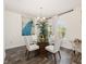 Bright dining room with modern chandelier, wood floors, and a glass table with seating for four at 9562 Sw 45Th Ave, Ocala, FL 34476