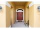 Close-up view of the entryway featuring a striking red door with decorative glass panels and sidelights at 9562 Sw 45Th Ave, Ocala, FL 34476