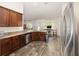 Well-equipped kitchen with stainless steel appliances, wooden cabinetry, and breakfast area at 9562 Sw 45Th Ave, Ocala, FL 34476