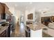 Modern kitchen with stainless steel appliances, wood cabinets, and a breakfast bar at 9562 Sw 45Th Ave, Ocala, FL 34476
